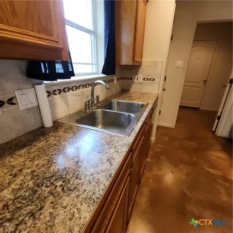 a kitchen with stainless steel appliances granite countertop a refrigerator stove and microwave