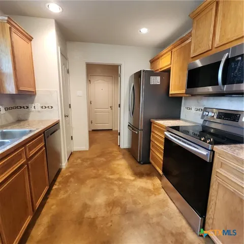 a kitchen with a refrigerator and a sink