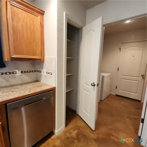 a view of storage and utility room with washer and dryer