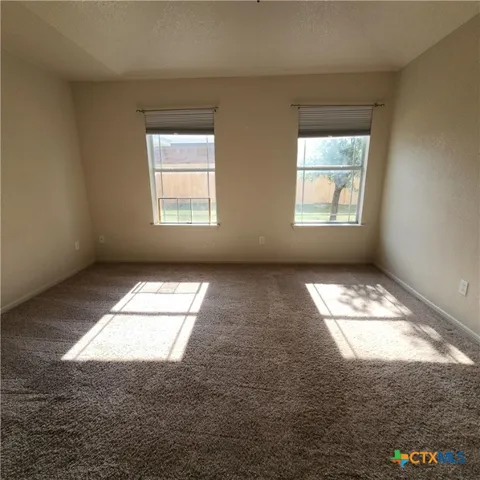 a view of empty room with windows