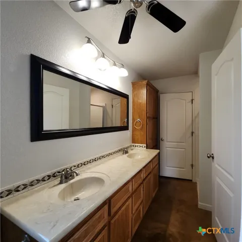 a bathroom with a sink a toilet and a mirror