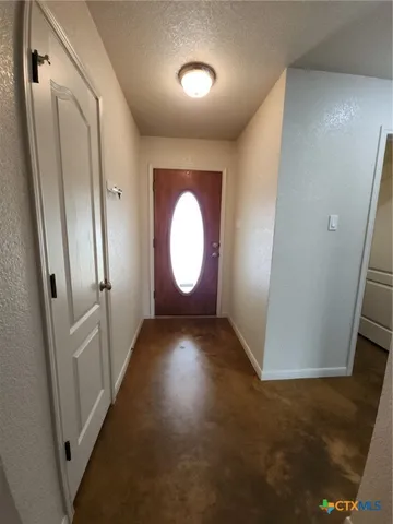 an empty room with wooden floor and mirror