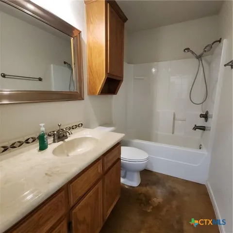 a view of a livingroom with a ceiling fan fireplace and a window
