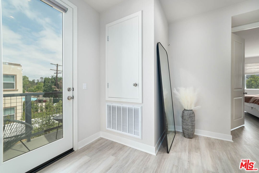 587 Daniel Freeman Circle Inglewood, CA 90301 - Photo 11 of 25 an empty room with wooden floor and a floor to ceiling window