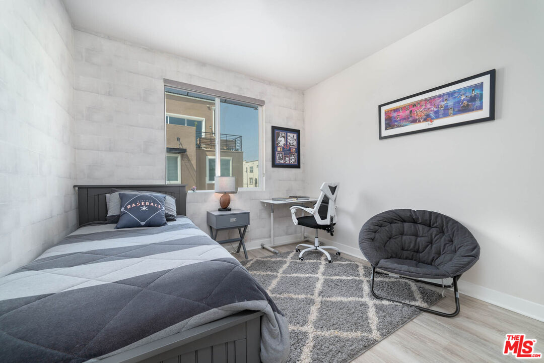 587 Daniel Freeman Circle Inglewood, CA 90301 - Photo 15 of 25 a bedroom with two beds and a chair