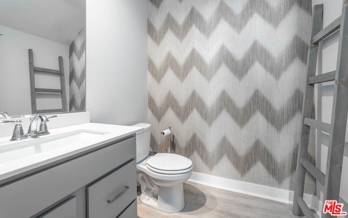 587 Daniel Freeman Circle Inglewood, CA 90301 - Photo 7 of 25 a bathroom with a granite countertop toilet and a sink