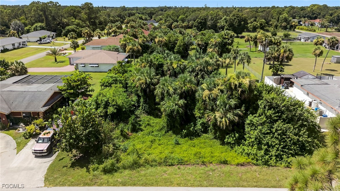 an aerial view of residential house with outdoor space and trees all around