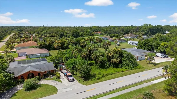 an aerial view of residential houses with outdoor space and street view