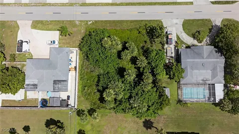 an aerial view of a house with a yard swimming pool