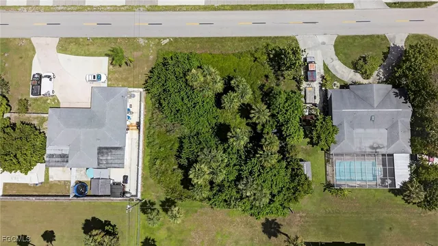 an aerial view of a house with a yard swimming pool