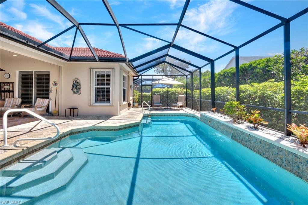 a view of a backyard with table and chairs under an umbrella