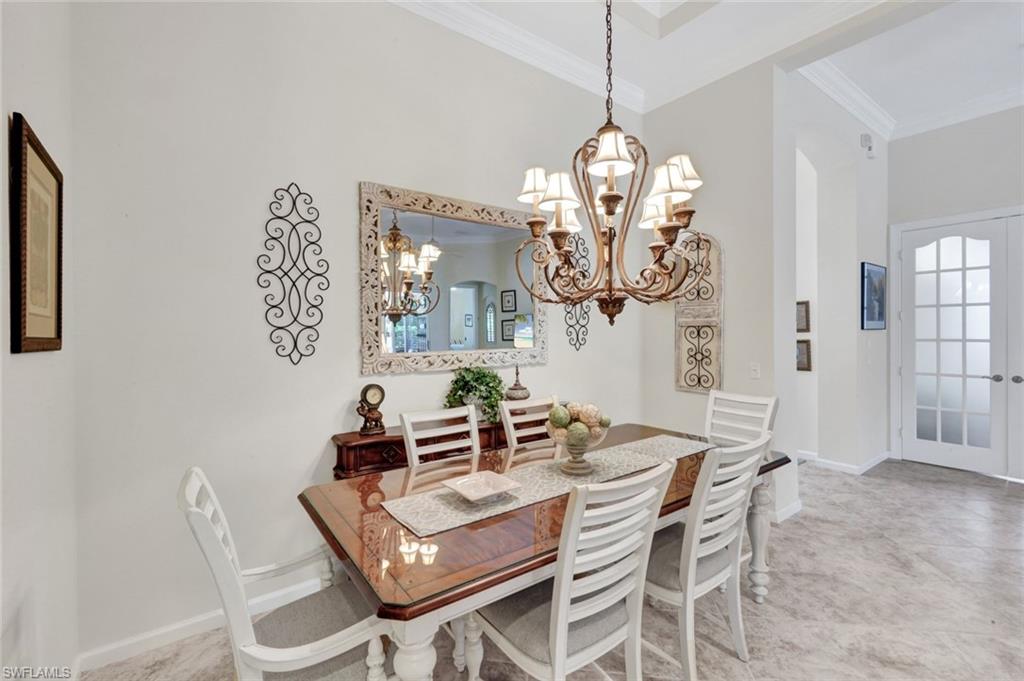 16208 Parque Lane Naples, FL 34110 - Photo 11 of 22 a view of a dining room with furniture a chandelier and wooden floor