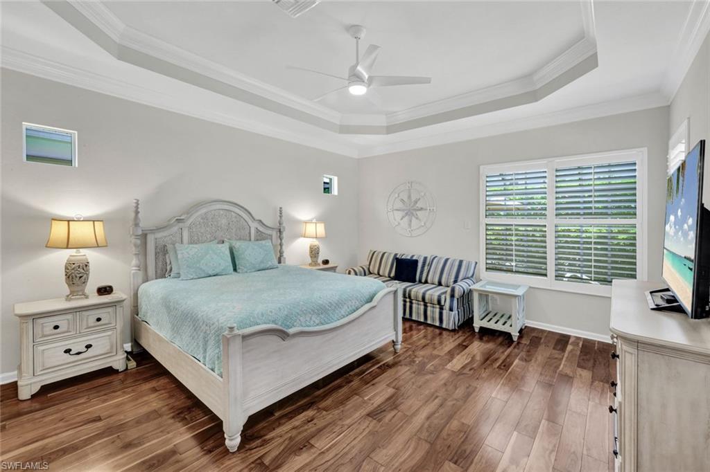16208 Parque Lane Naples, FL 34110 - Photo 12 of 22 a bedroom with a bed and a large window