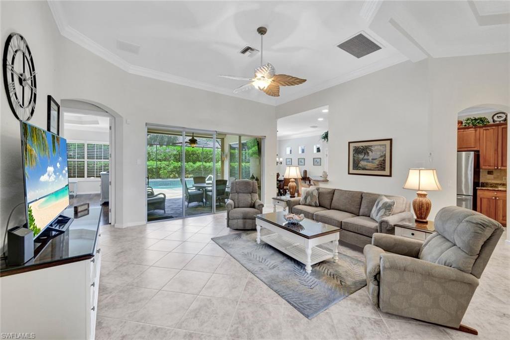 16208 Parque Lane Naples, FL 34110 - Photo 4 of 22 a living room with furniture a flat screen tv and a large window
