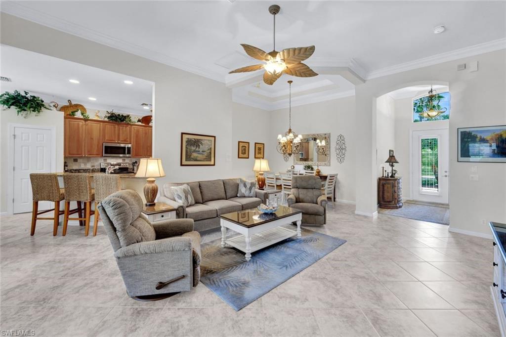 16208 Parque Lane Naples, FL 34110 - Photo 5 of 22 a living room with furniture and a chandelier