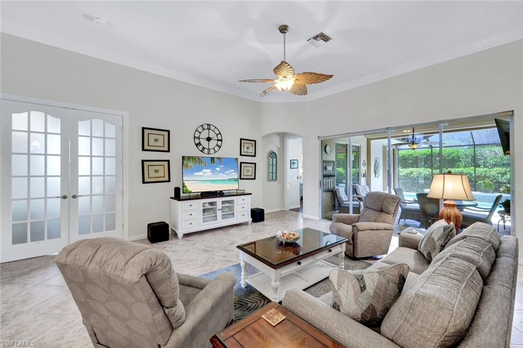16208 Parque Lane Naples, FL 34110 - Photo 6 of 22 a living room with furniture a flat screen tv and a large window
