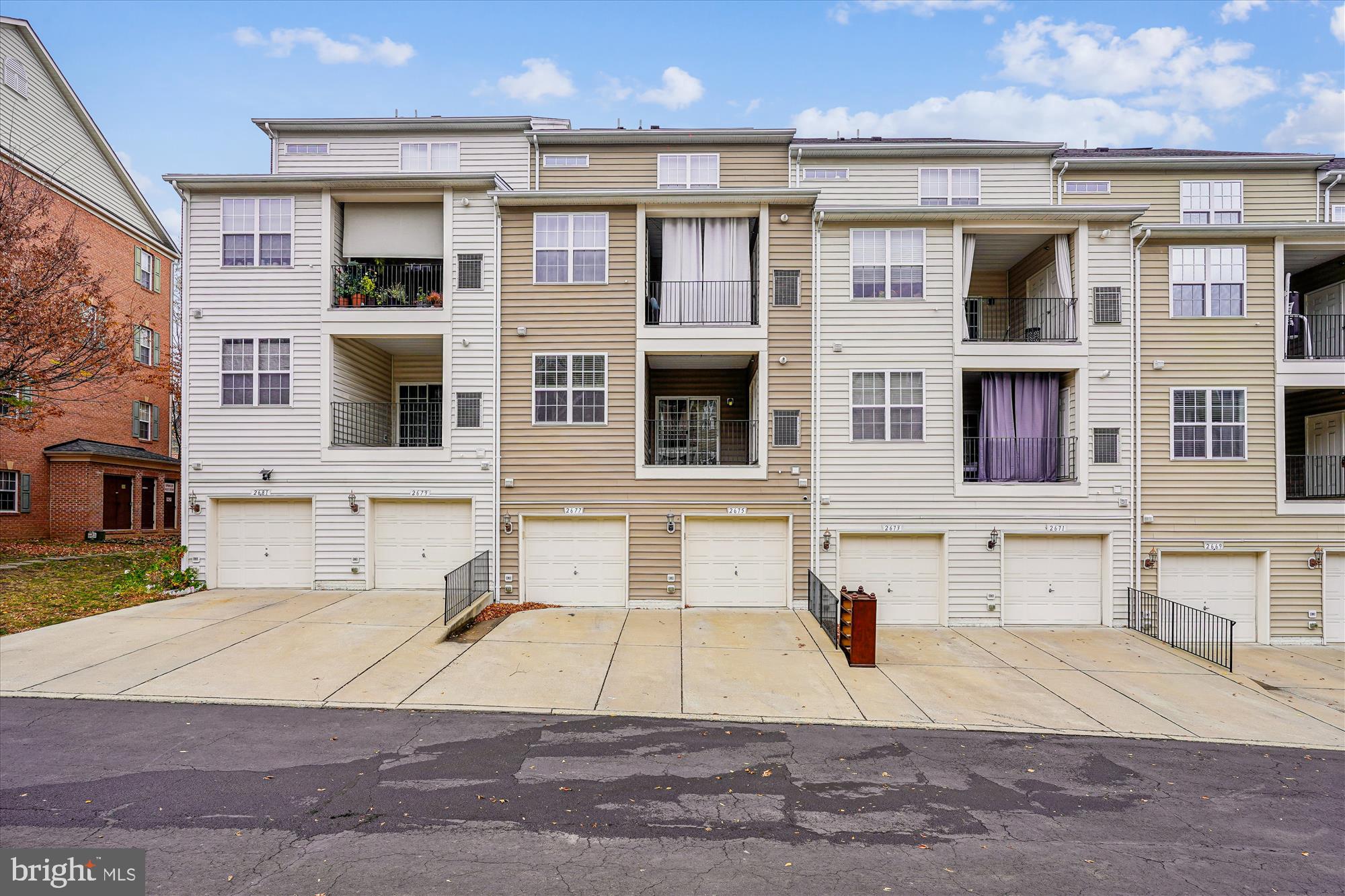 2675 Sheffield Hill Way, Unit 164 Woodbridge, VA 22191 - Photo 20 of 37 a view of a brick house with many windows and a yard