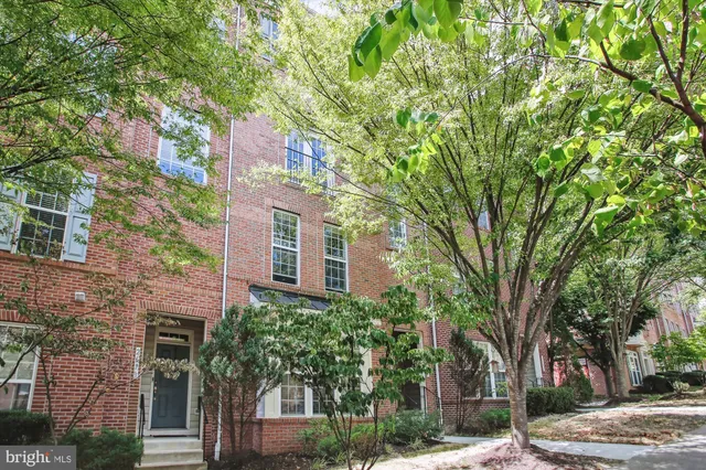 a front view of a residential apartment building with a yard