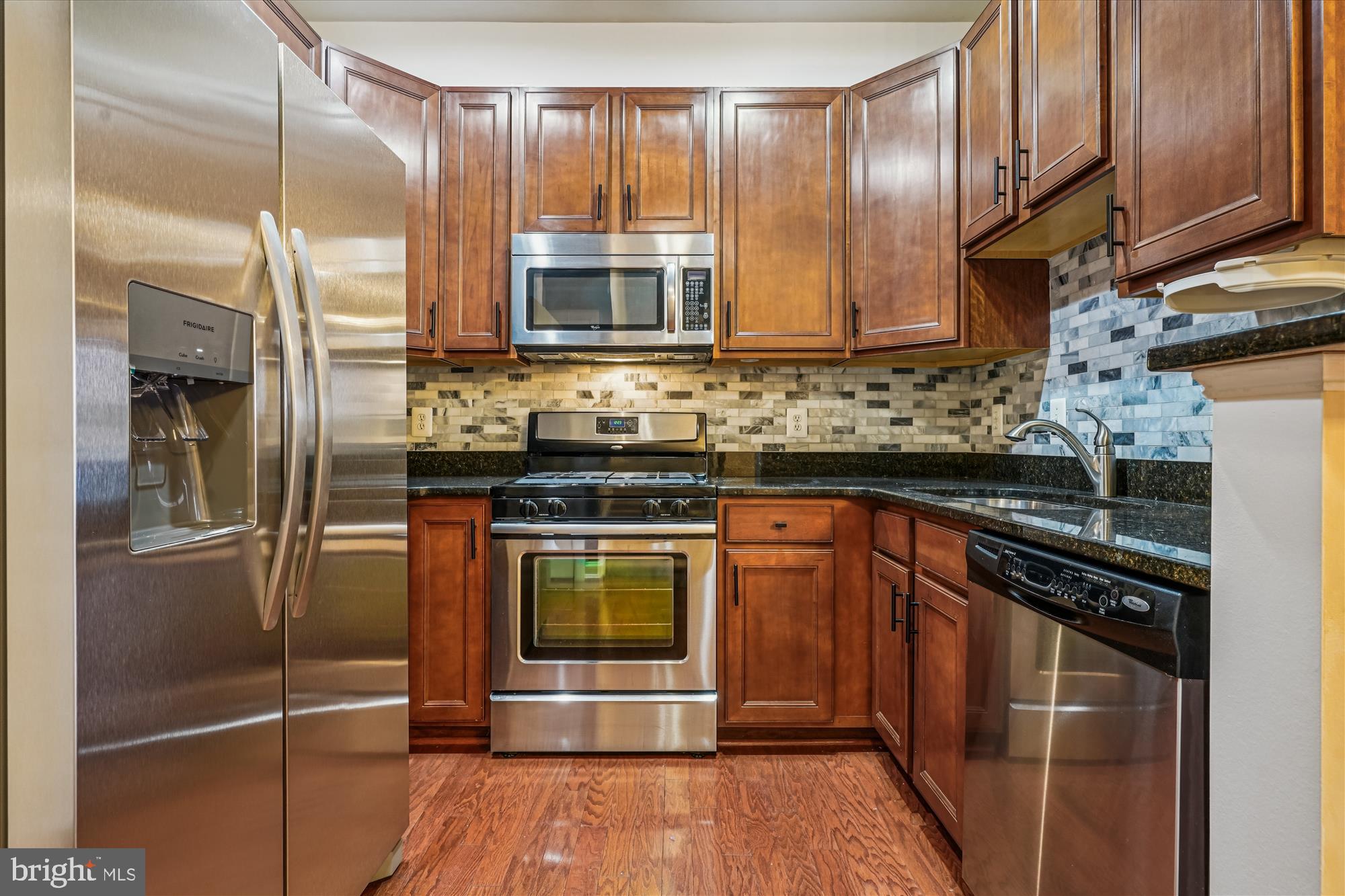 2675 Sheffield Hill Way, Unit 164 Woodbridge, VA 22191 - Photo 5 of 37 a kitchen with stainless steel appliances granite countertop a stove a refrigerator and a sink