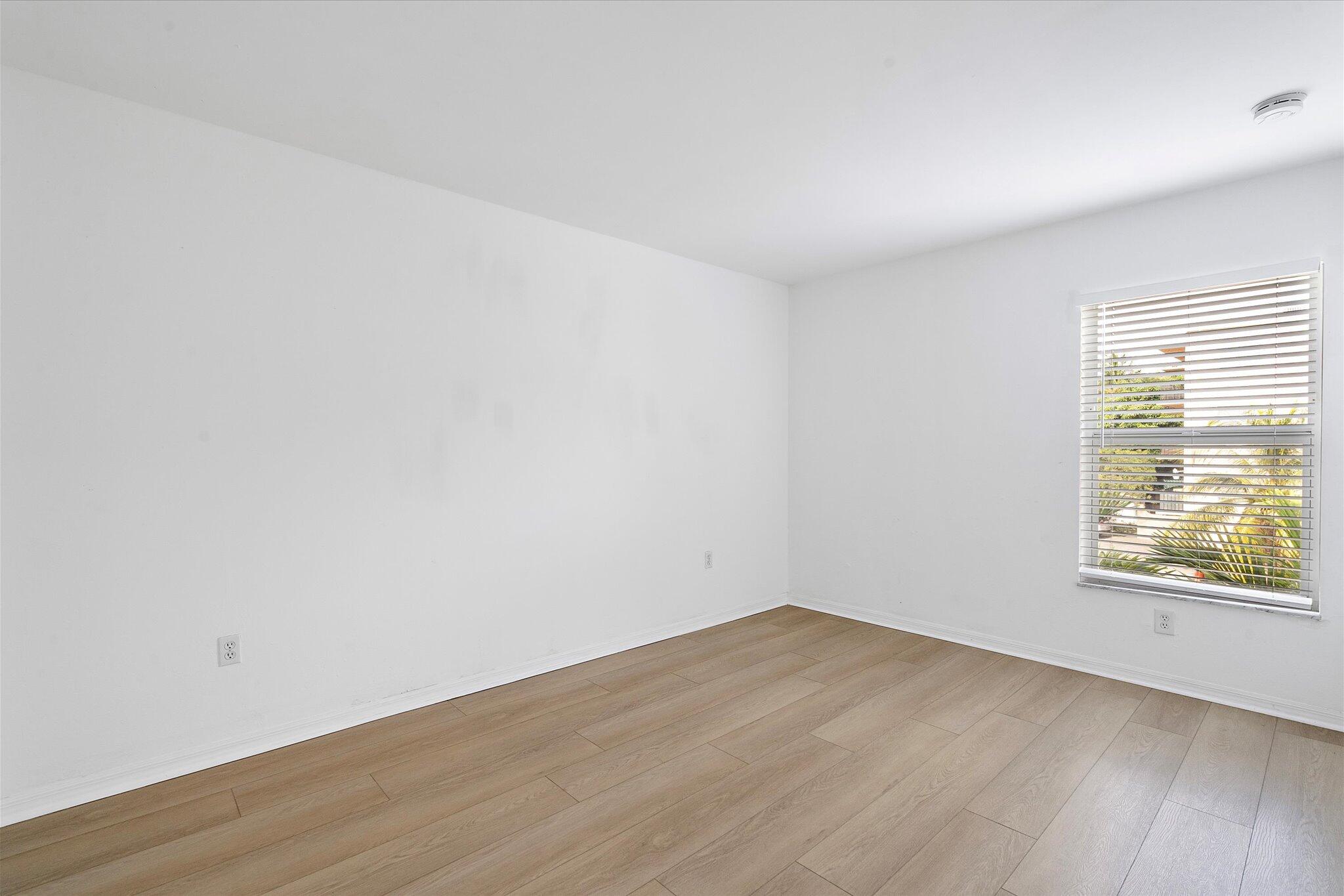 2138 Southwest 6th Street, Unit 301 Miami, FL 33135 - Photo 13 of 15 wooden floor in an empty room with a window