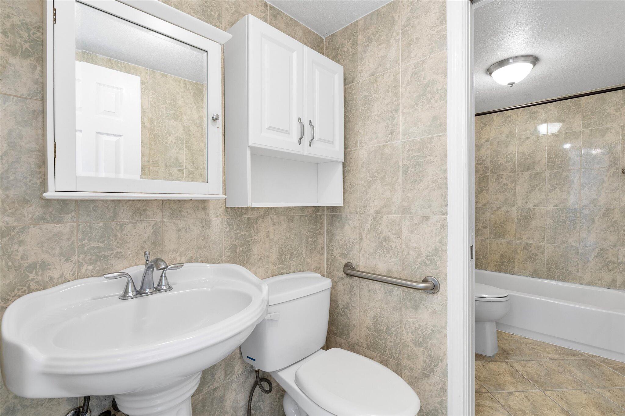 2138 Southwest 6th Street, Unit 301 Miami, FL 33135 - Photo 14 of 15 a bathroom with a sink a toilet and shower