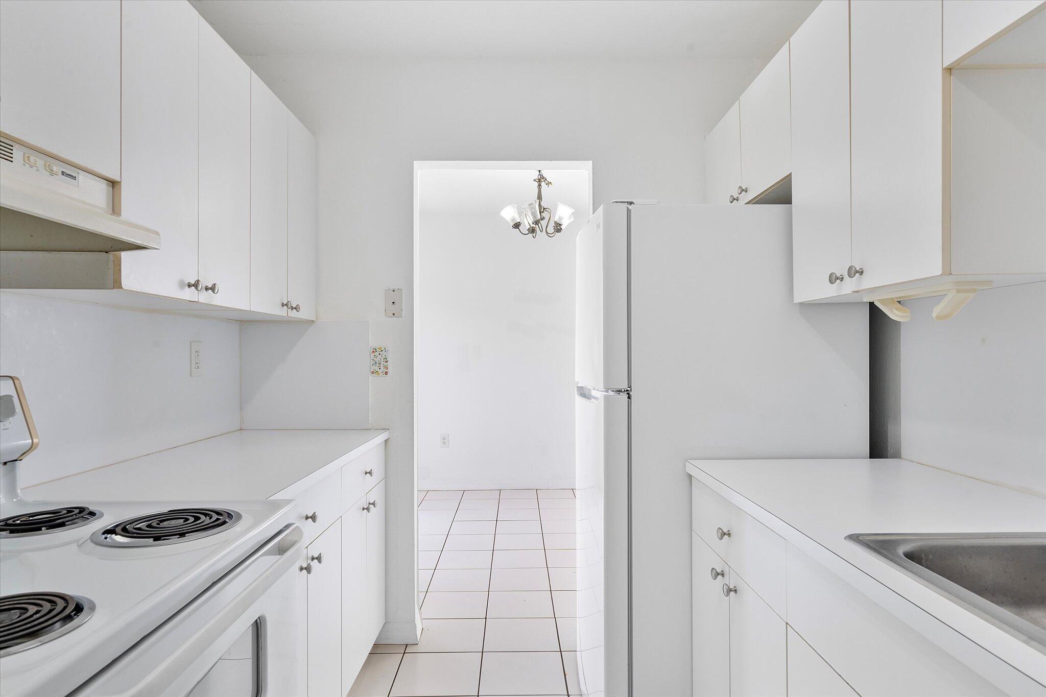 2138 Southwest 6th Street, Unit 301 Miami, FL 33135 - Photo 6 of 15 a kitchen with a stove and a refrigerator
