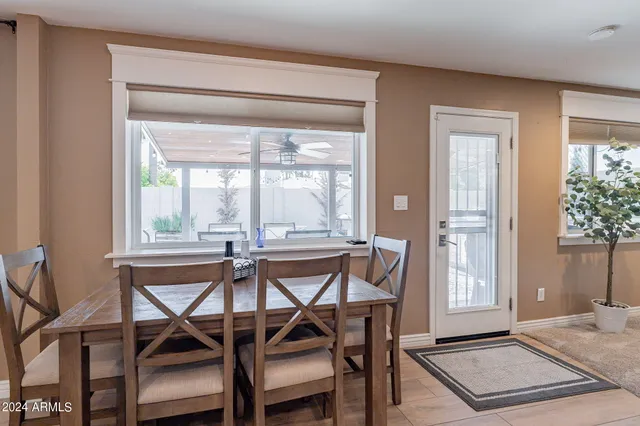 a dining room with furniture window and wooden floor