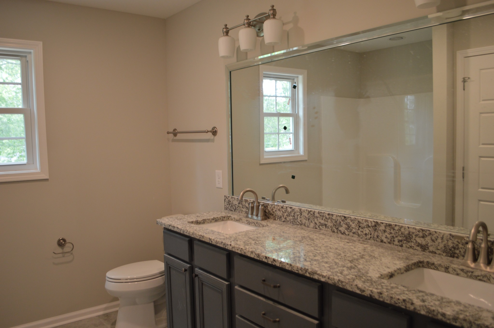 7713 South Swift Road Goodlettsville, TN 37072 - Photo 15 of 18 a bathroom with a granite countertop sink a toilet and a window