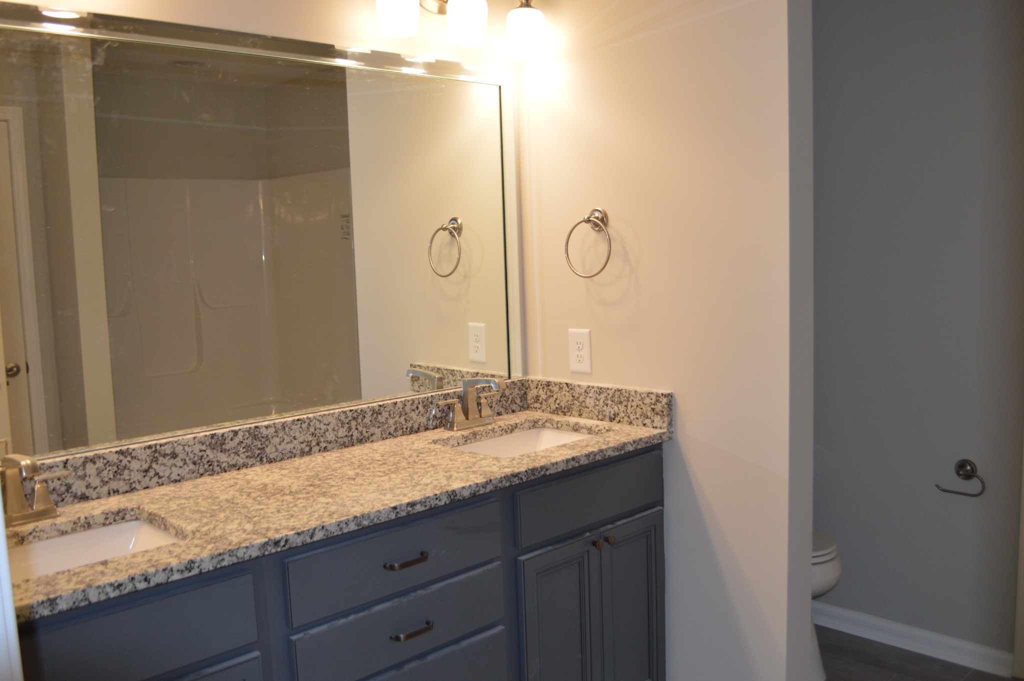 7713 South Swift Road Goodlettsville, TN 37072 - Photo 16 of 18 a bathroom with a granite countertop sink and a mirror
