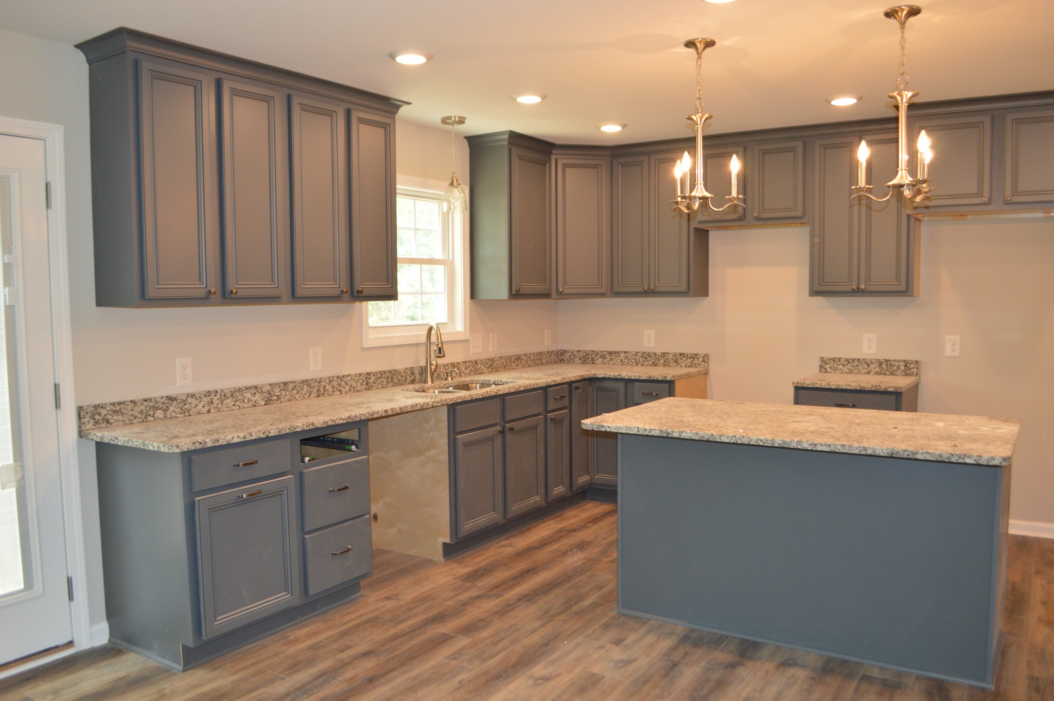 7713 South Swift Road Goodlettsville, TN 37072 - Photo 3 of 18 a kitchen with kitchen island granite countertop a sink a counter top space appliances and cabinets