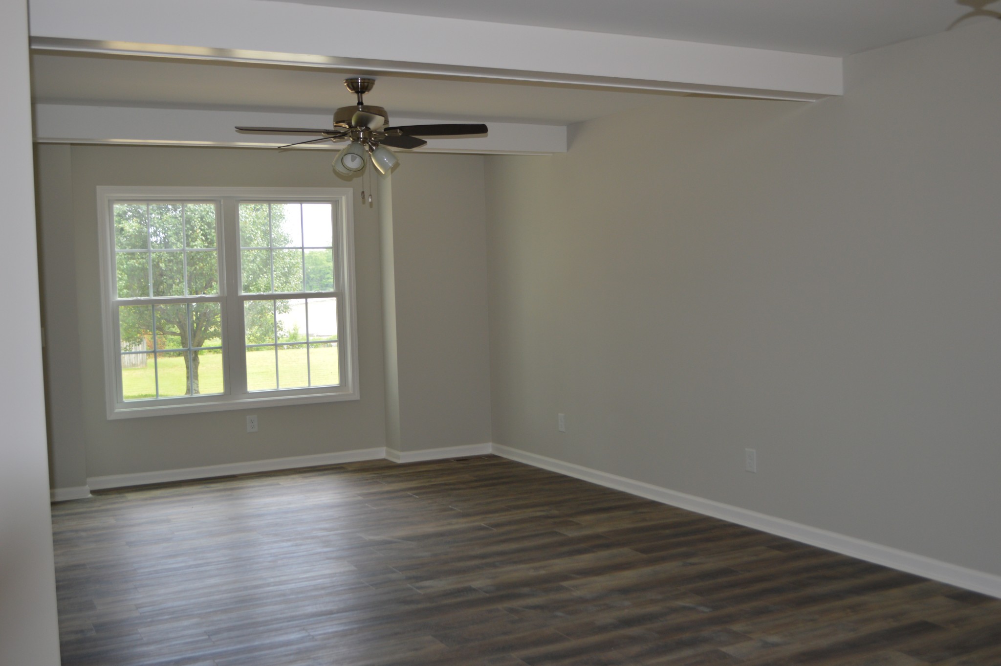 7713 South Swift Road Goodlettsville, TN 37072 - Photo 5 of 18 wooden floor in an empty room with a window