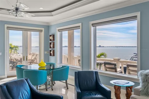 a view of a swimming pool with outdoor seating and plants