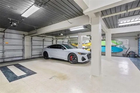 a view of a roof deck with table and chairs with wooden floor and fence
