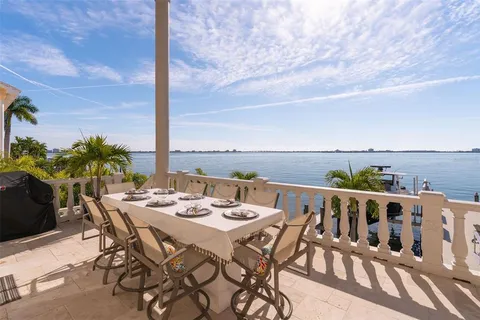 a view of a patio with swimming pool and sitting area