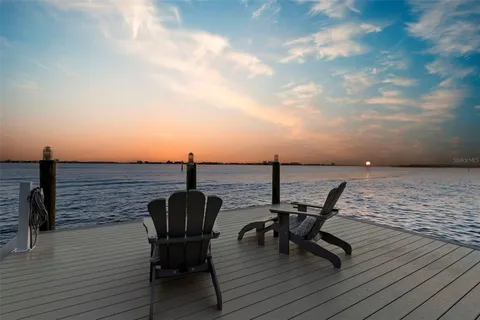 a view of a swimming pool with outdoor seating