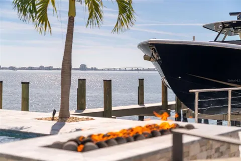 a view of a house with backyard porch and sitting area