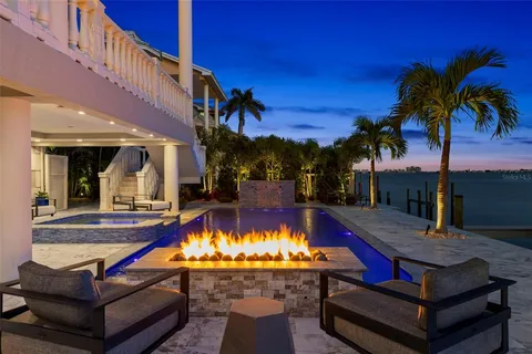 a living room with furniture a flat screen tv and a table