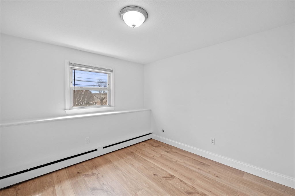 121 Cambridge Road, Unit 2 Woburn, MA 01801 - Photo 18 of 23 an empty room with a window