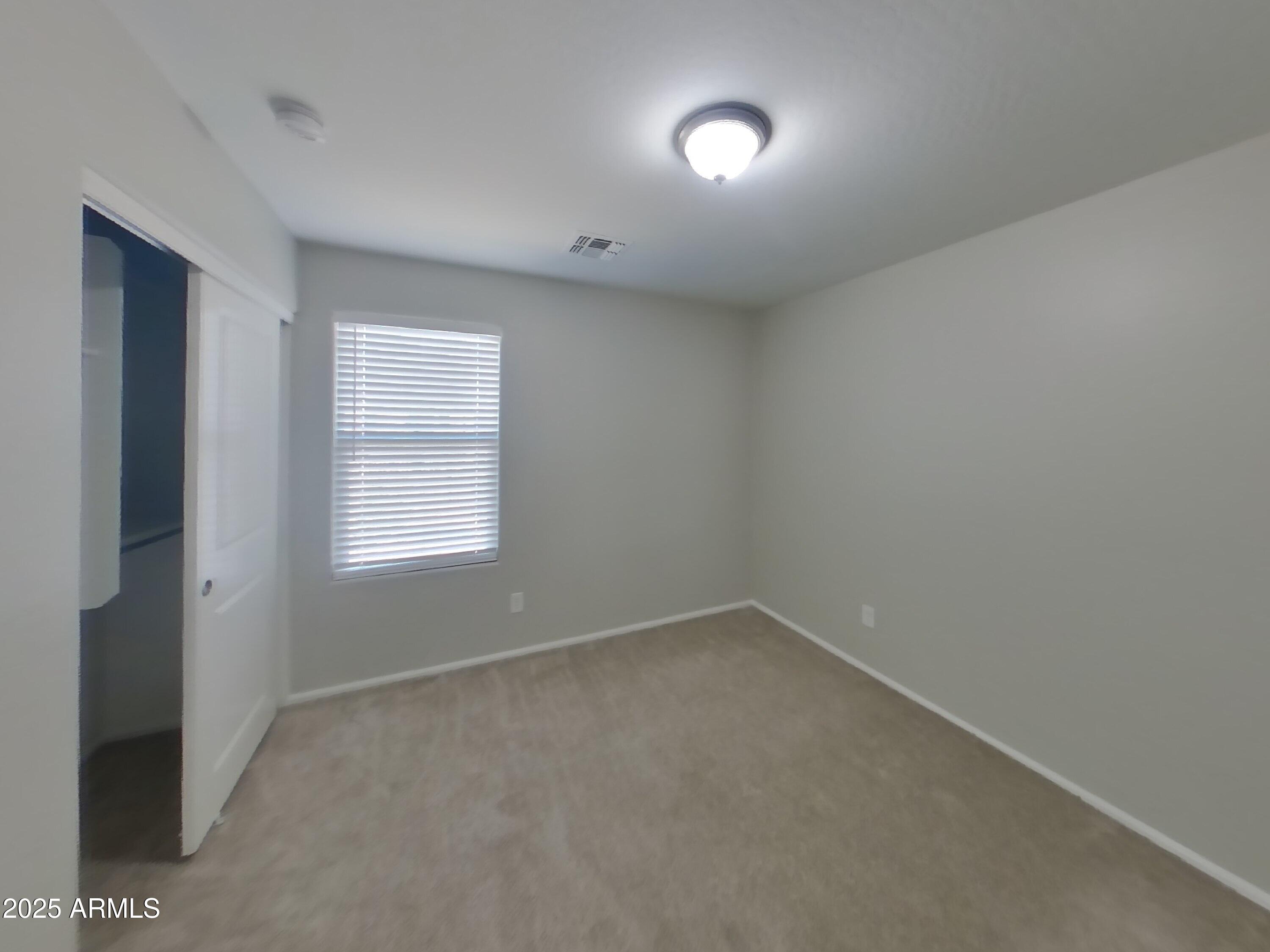 3513 South 89th Avenue Tolleson, AZ 85353 - Photo 10 of 19 an empty room with a empty space and windows