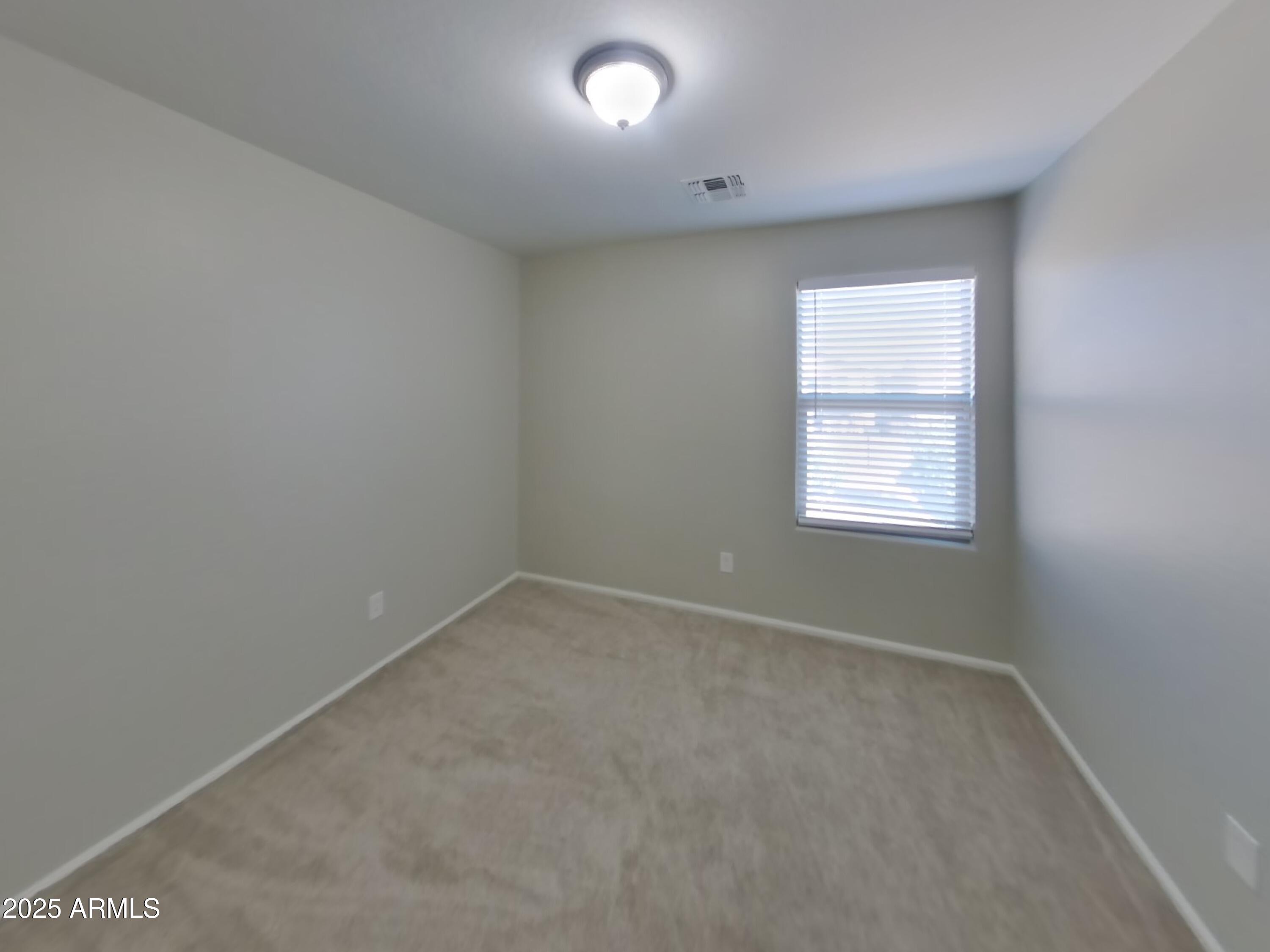3513 South 89th Avenue Tolleson, AZ 85353 - Photo 11 of 19 an empty room with a window