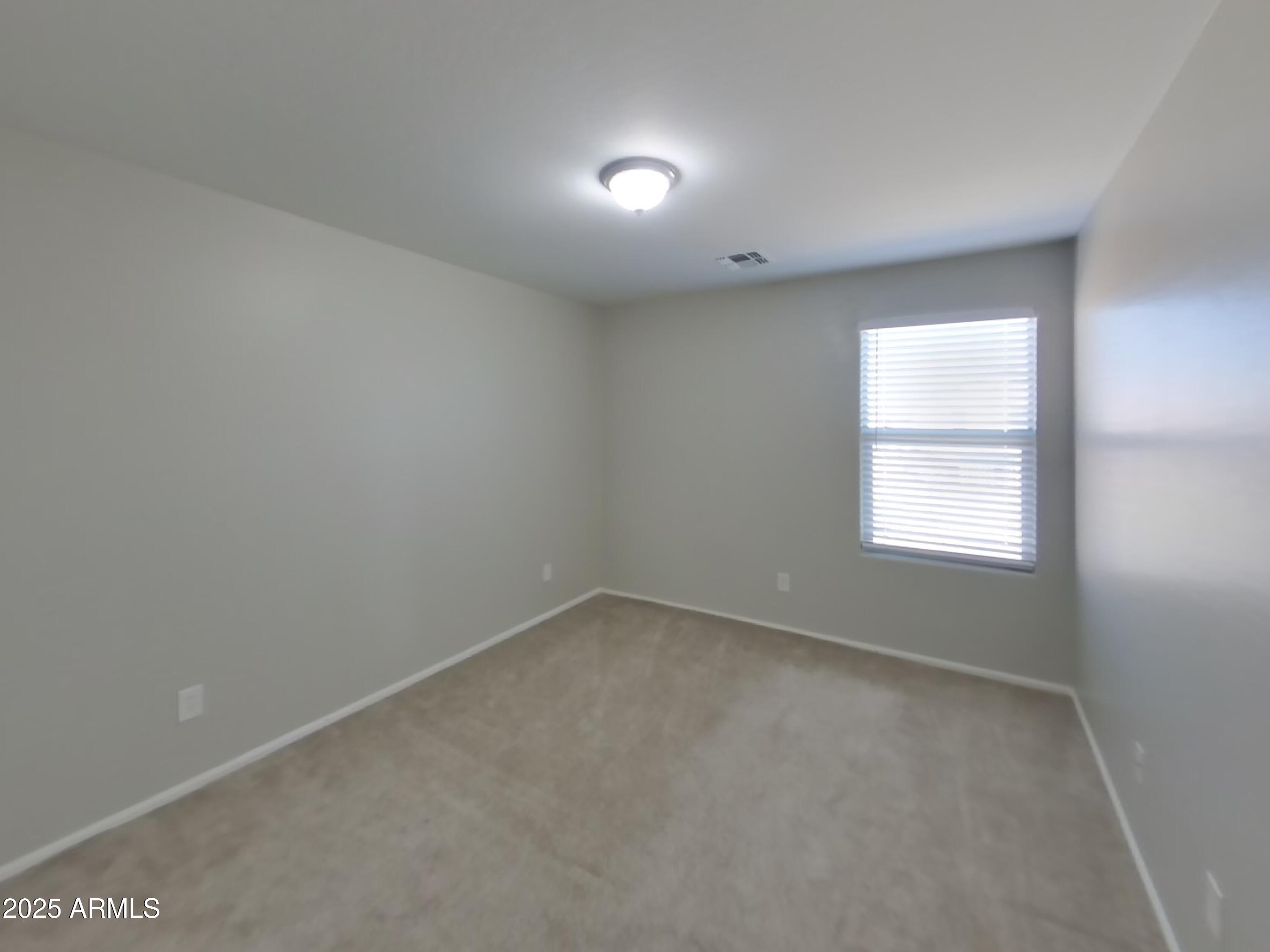 3513 South 89th Avenue Tolleson, AZ 85353 - Photo 14 of 19 an empty room with a window