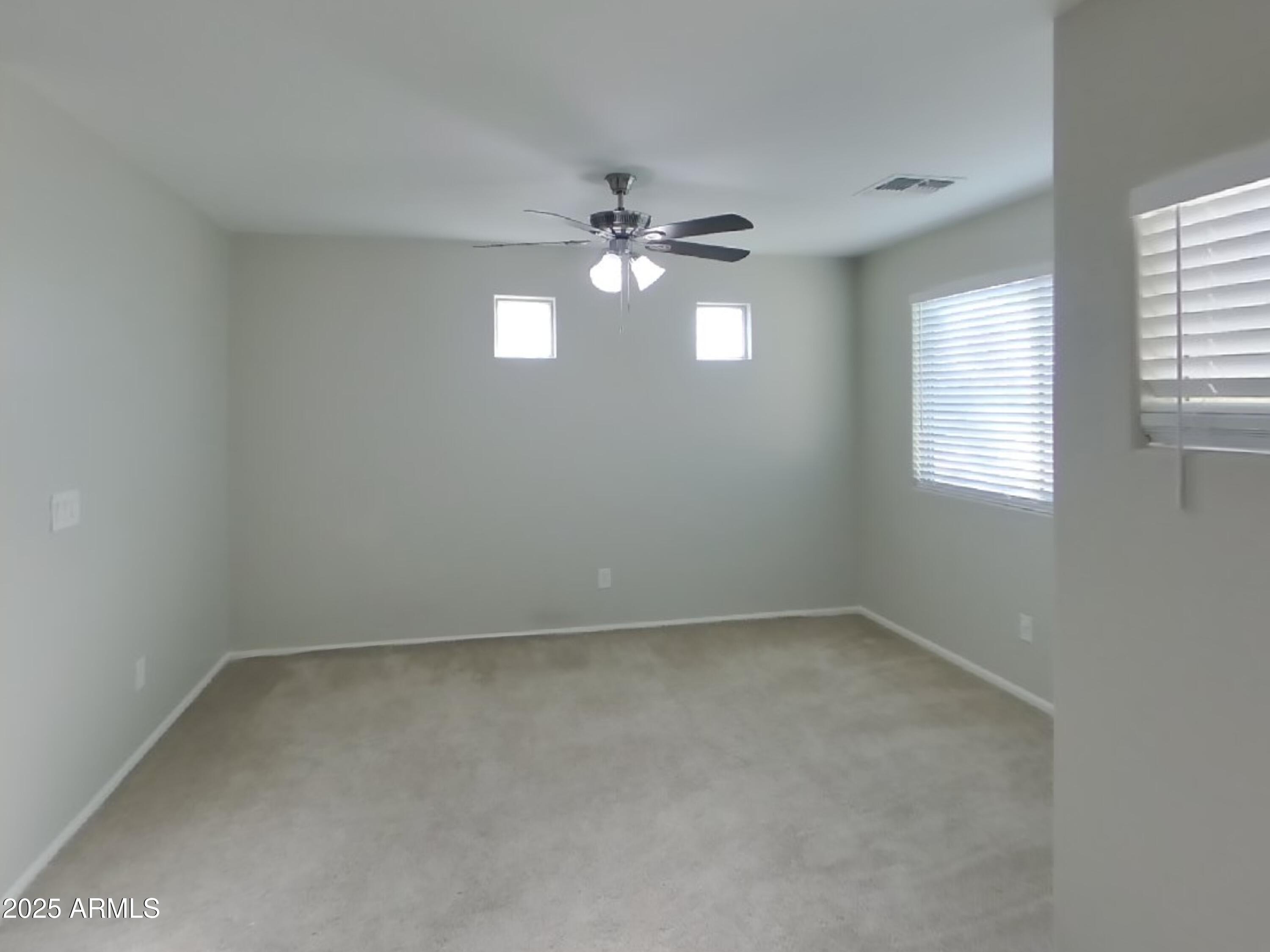 3513 South 89th Avenue Tolleson, AZ 85353 - Photo 17 of 19 an empty room with windows and fan