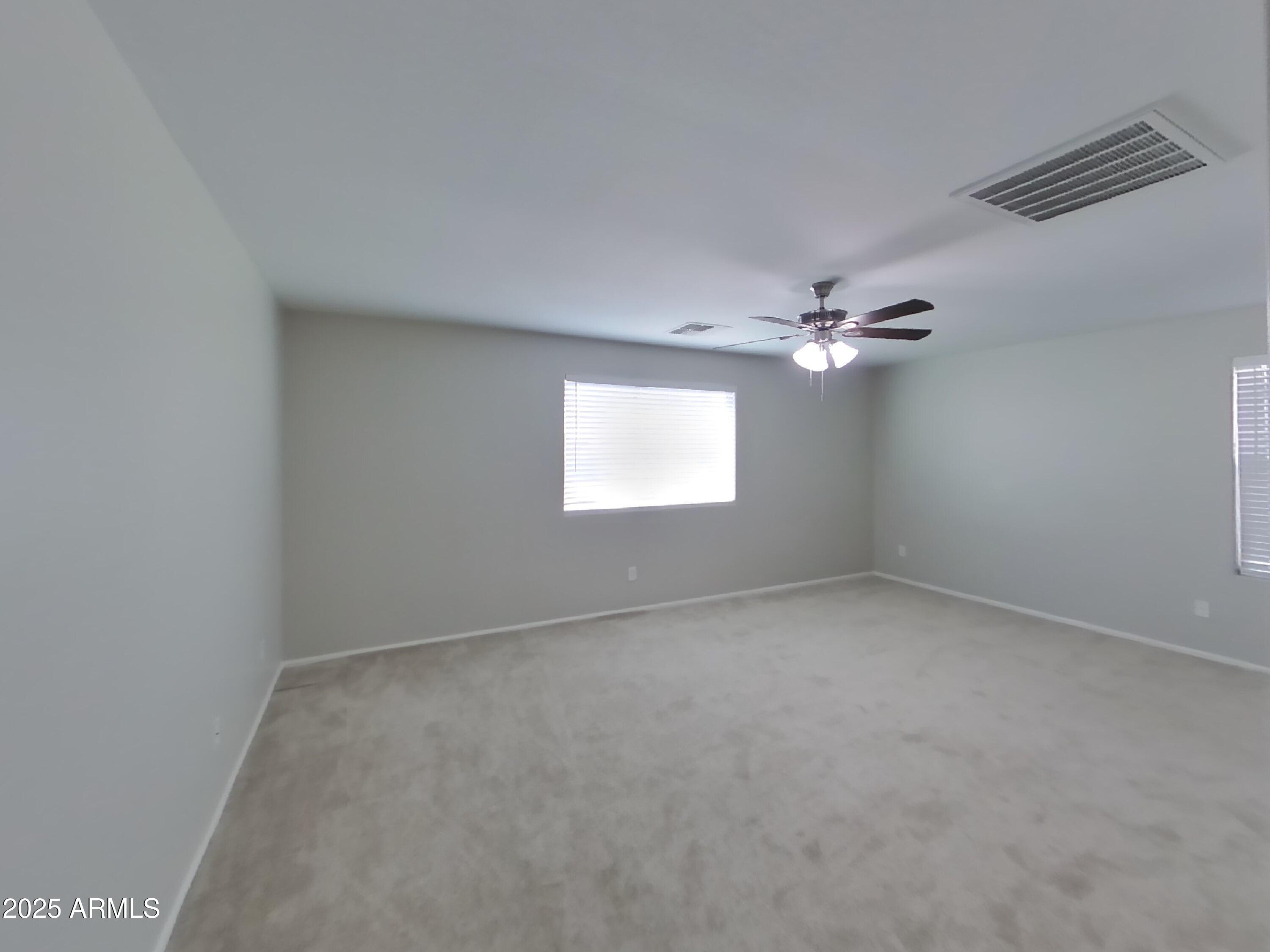 3513 South 89th Avenue Tolleson, AZ 85353 - Photo 6 of 19 a view of an empty room with a window
