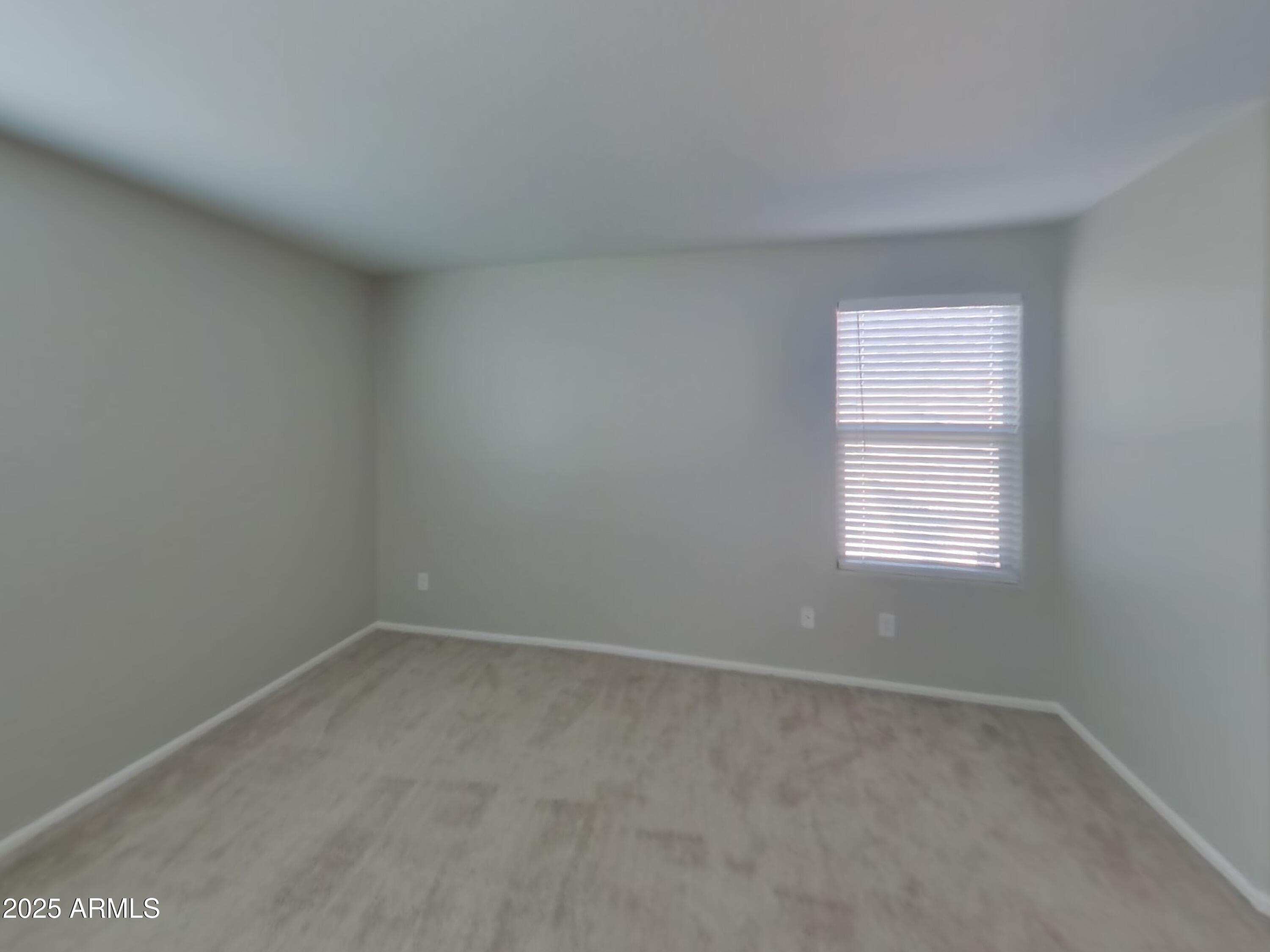 3513 South 89th Avenue Tolleson, AZ 85353 - Photo 7 of 19 an empty room with a window