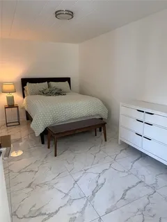 a bedroom with a bed and a night stand