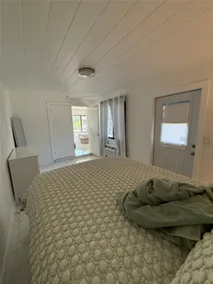 a view of a hallway with furniture and a window
