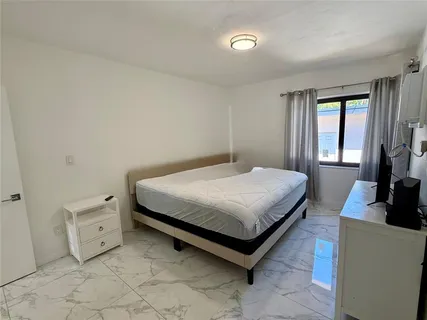 a bed room with a bed and a rug