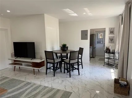 a view of a livingroom with furniture and a flat screen tv
