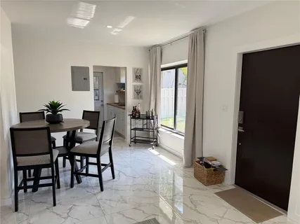 a dining room with furniture and wooden floor