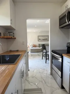 a kitchen with stainless steel appliances granite countertop a sink and a stove